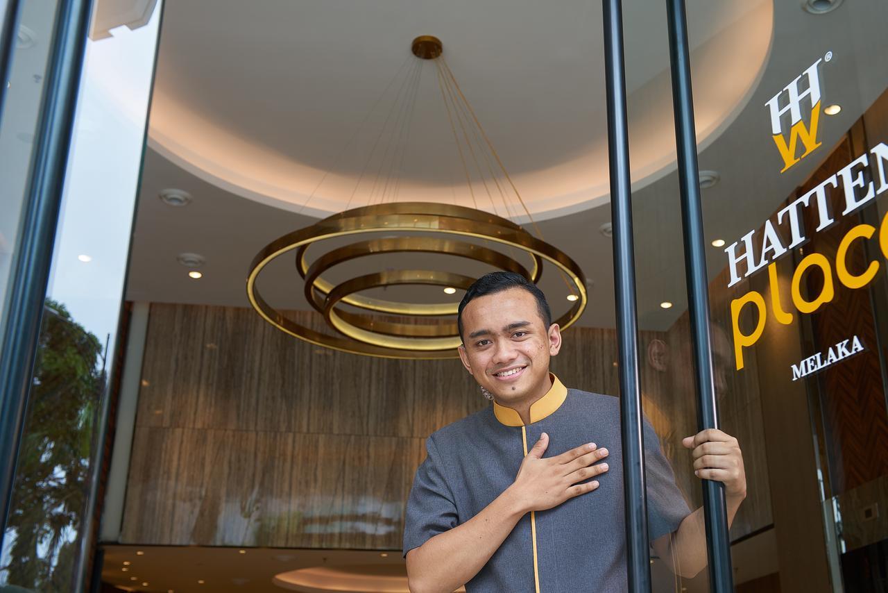 Hatten Place Melaka Bagian luar foto A doorman at the entrance of a hotel in Malaysia.